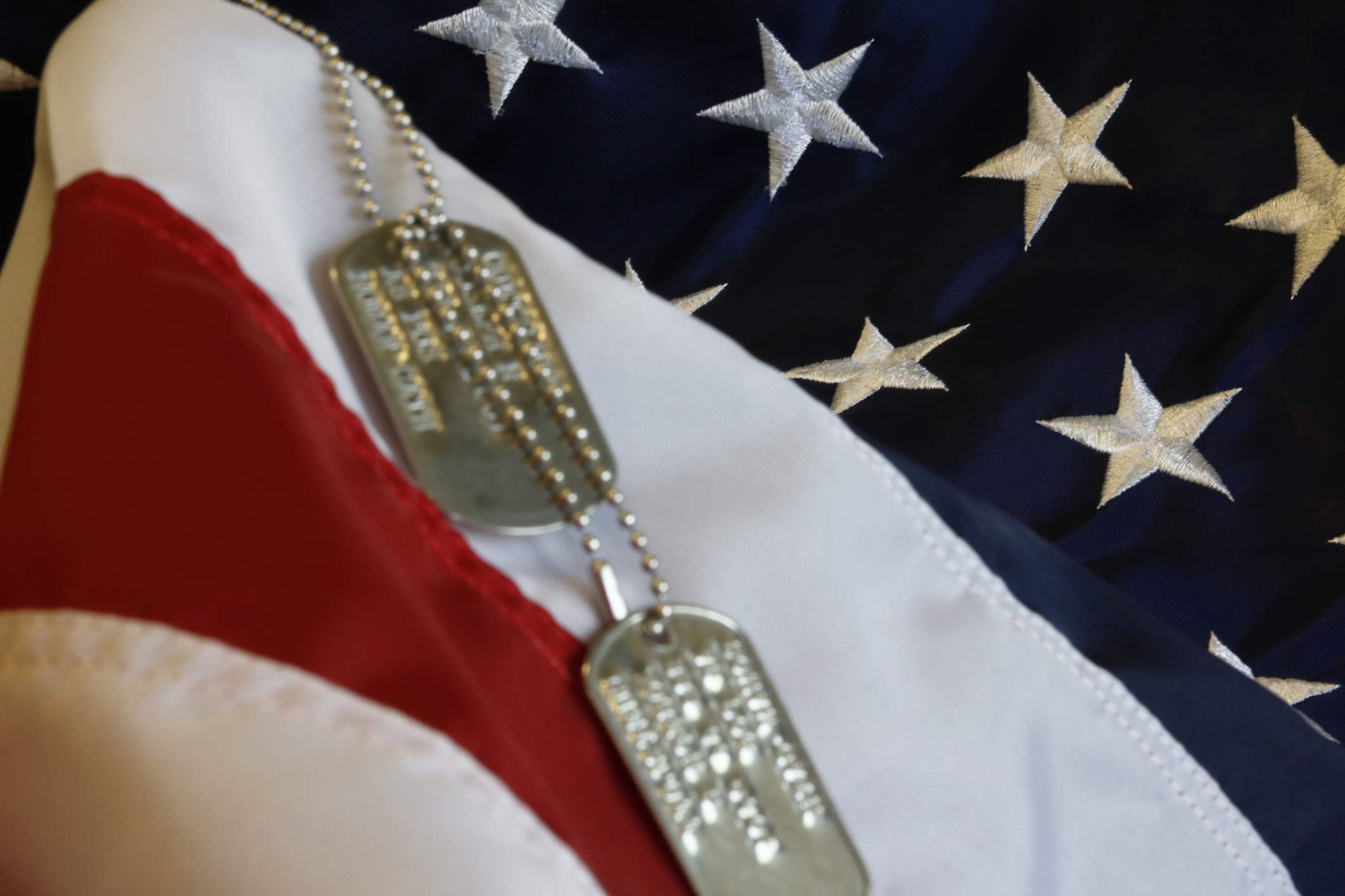 usa flag with dog tags laying on top
